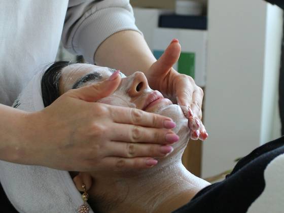 Woman receiving a facial massage. (c) unsplash.com